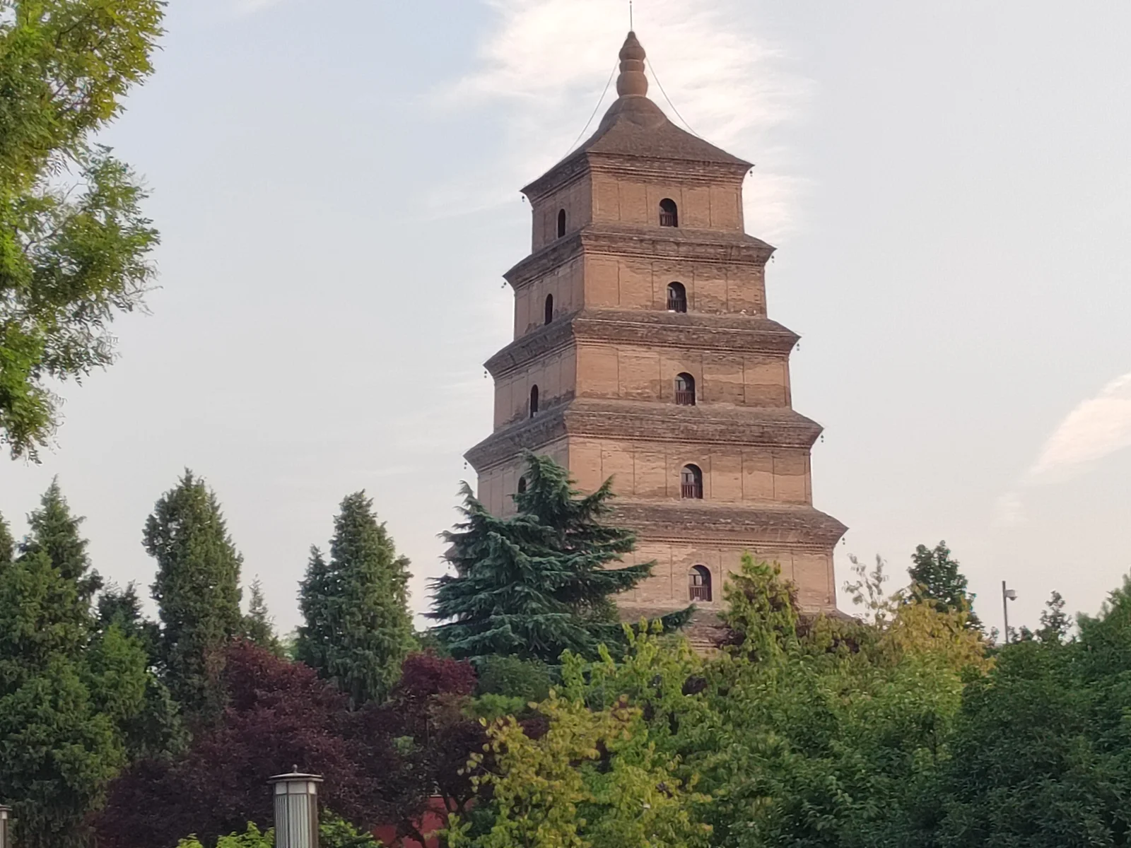 The brick Giant Wild Goose Pagoda rising above green trees in Xi’an