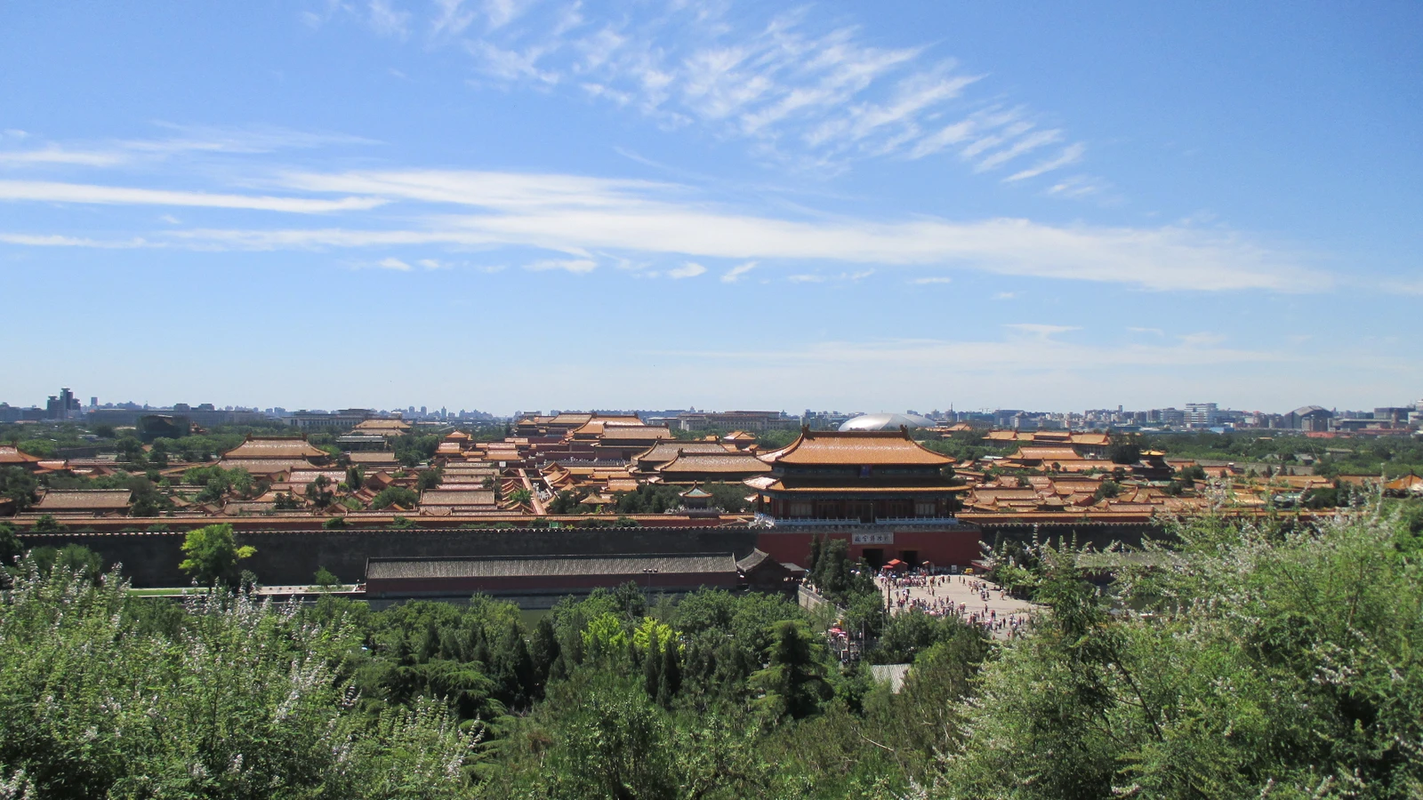 The Forbidden City roofs and imperial courtyards seen from Jingshan under a clear blue sky
