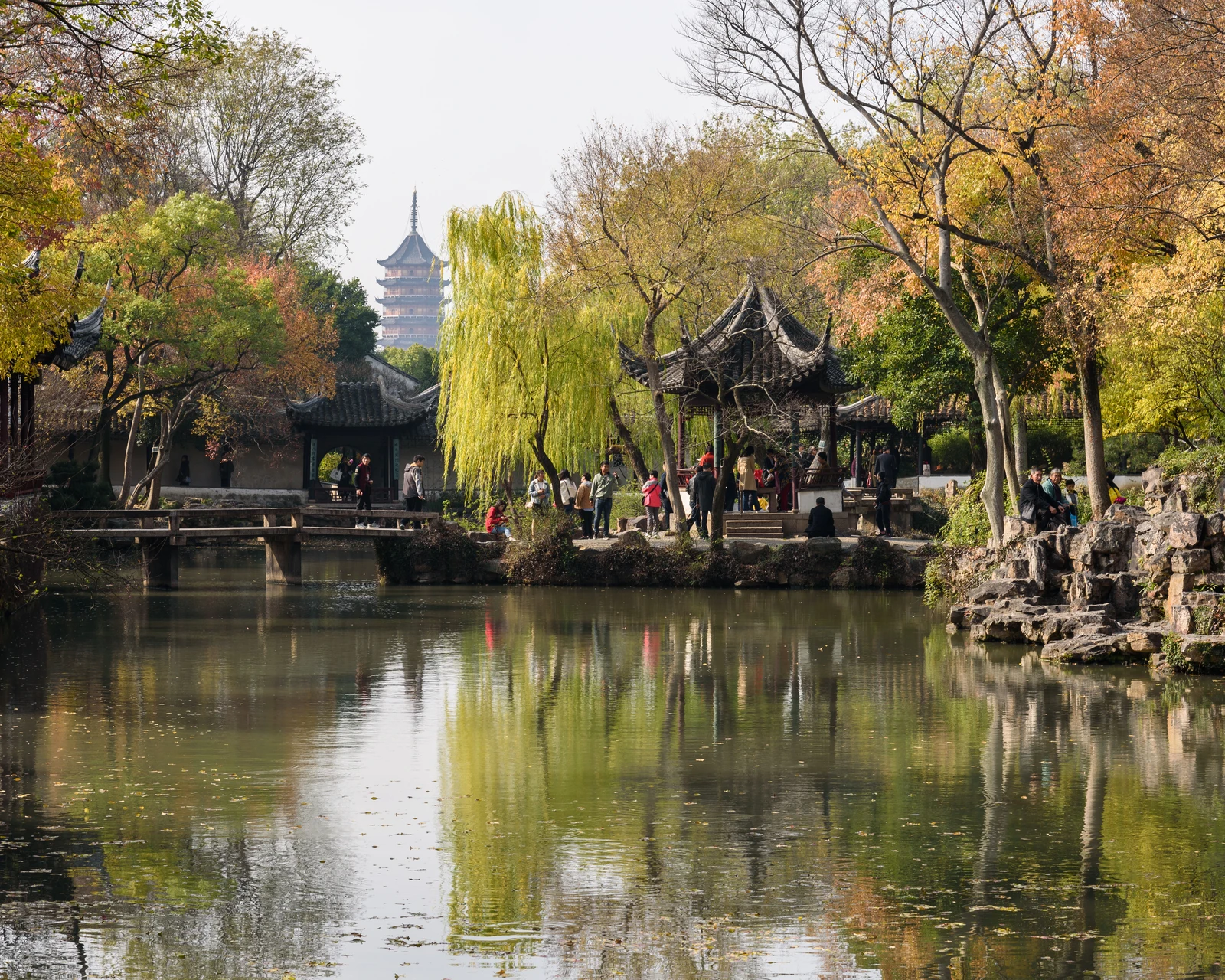 Autumn trees and a traditional waterside pavilion in Suzhou Humble Administrator’s Garden
